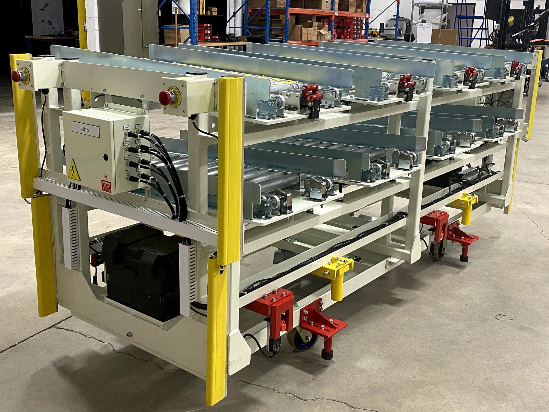 Battery-powered roller shuttle cart with safety bumpers and E-stops