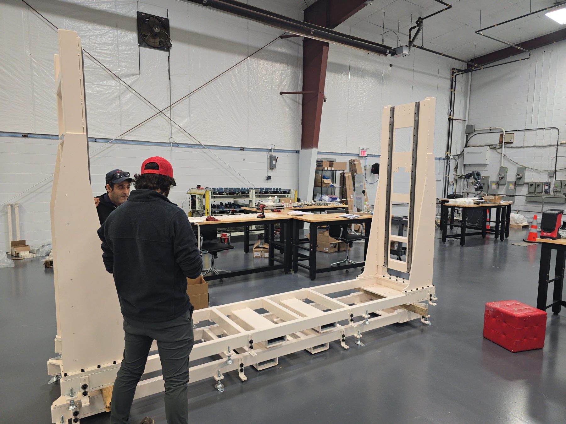 Two PH Engineering staff working together on a machine build in the Woodstock shop