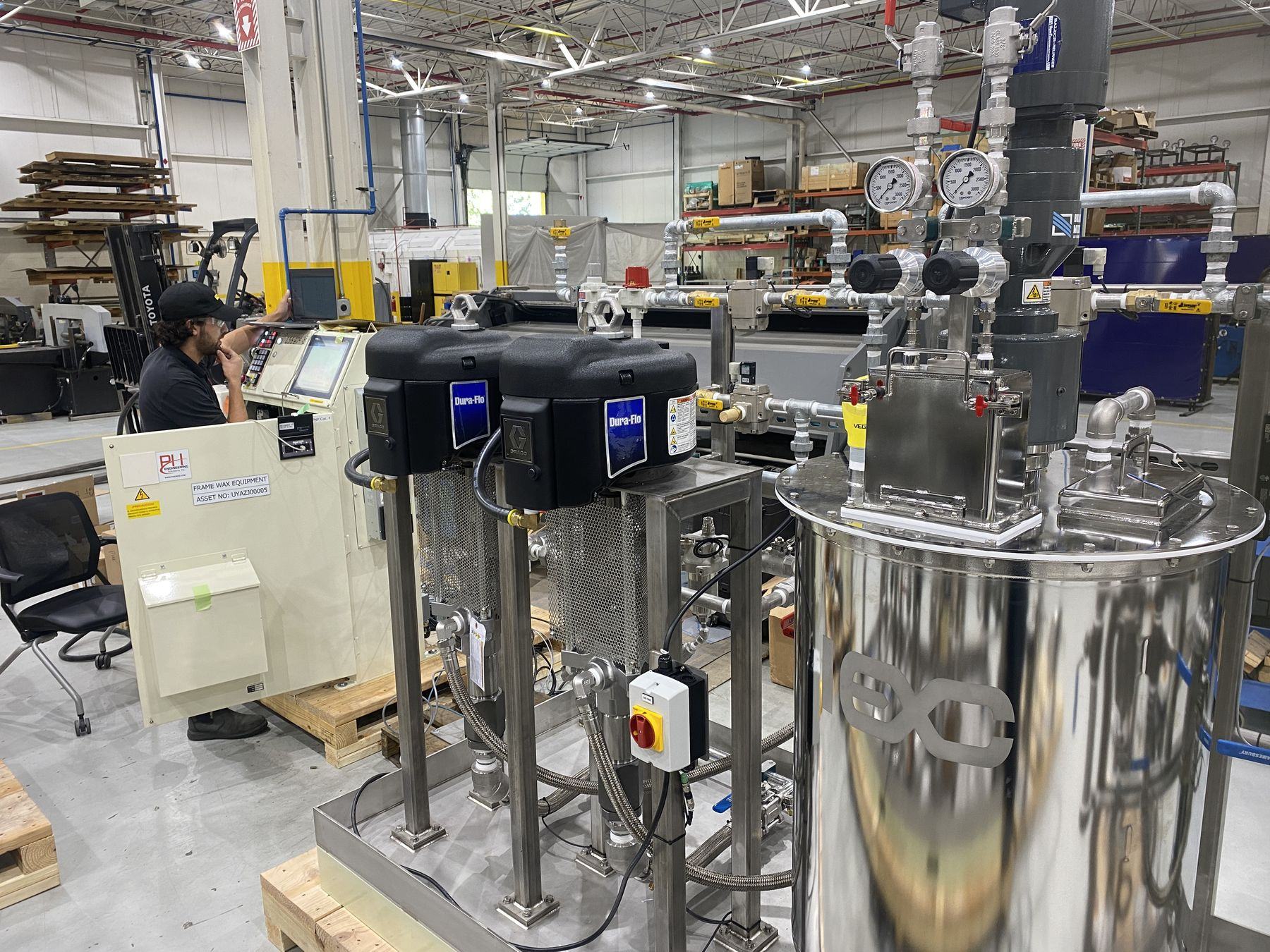 PH engineer commissioning the frame wax equipment control panel inside the plant